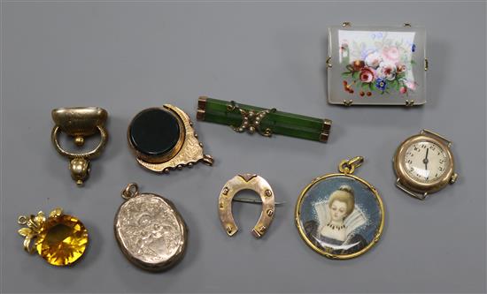 An early 20th century 9ct gold and carnelian spinning fob, one other fob, a locket, two pendants, three brooches and a ladys watch.